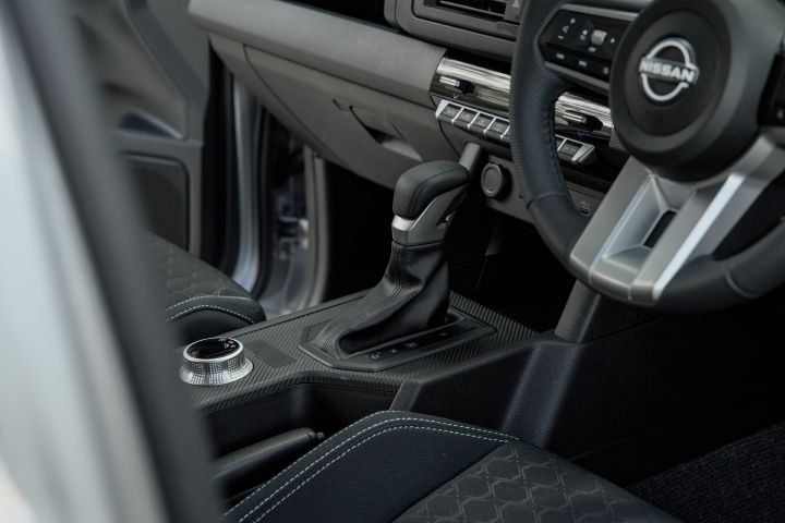 2026 Nissan Navara ST dual cab ute finished in Summit Silver featuring a detailed interior view of the steering wheel, dashboard and infotainment display.