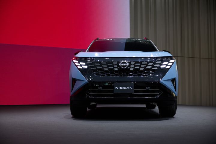 Front view of the 2027 Nissan Rogue Hybrid e‑POWER on a stage.