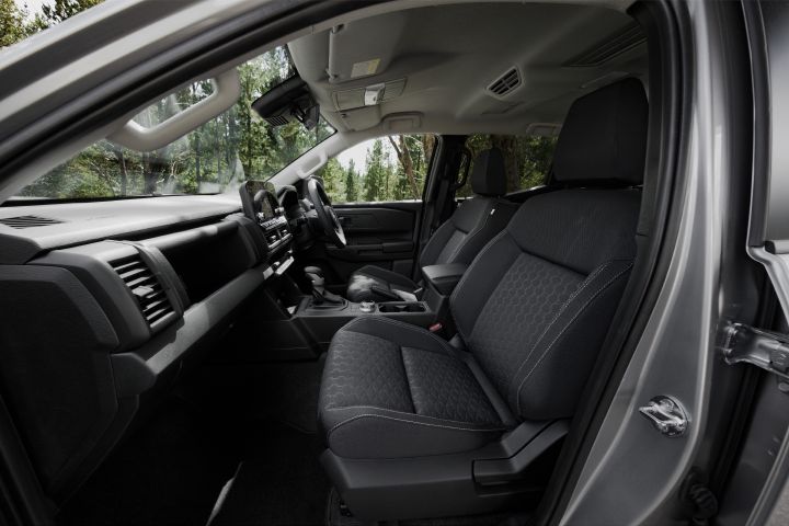 2026 Nissan Navara ST dual cab ute finished in Summit Silver featuring a close-up of the infotainment screen with smartphone app interface and controls.