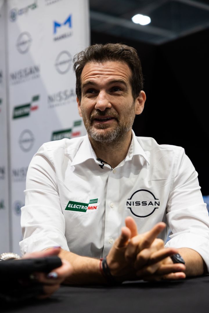Tommaso Volpe spricht in seinem weißen Nissan Formula E Hemd lächelnd mit den Medien.