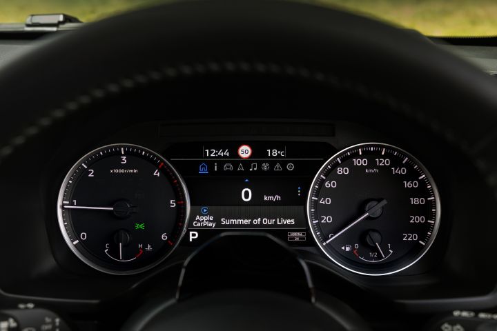 2026 Nissan Navara PRO-4X finished in Boulder Grey showing the instrument display with Apple CarPlay audio, digital speed readout and a 50 km/h speed-limit icon.