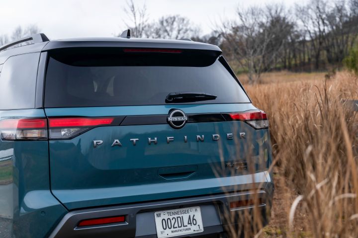 Rear view of the 2026 Nissan Pathfinder parked in a grassy field.