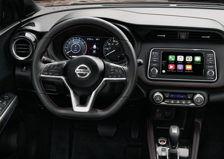 The steering wheel and and in dash display in a Nissan Kicks