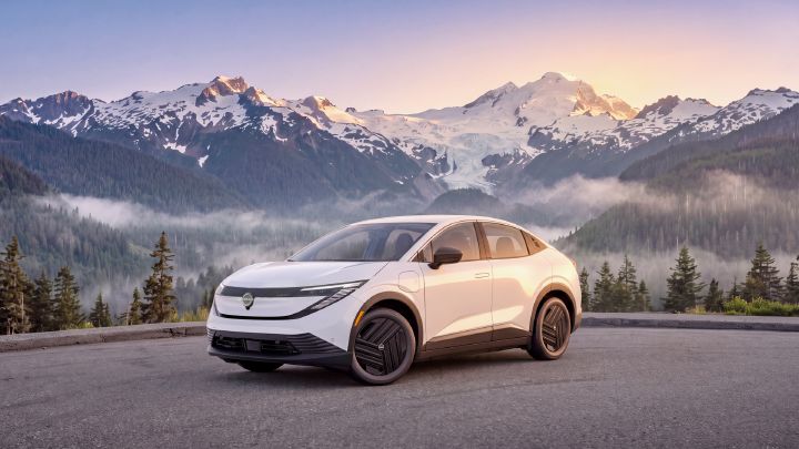 2027 Nissan LEAF S with mountains and forest landscape in the background.