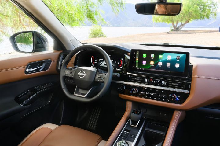 The steering wheel, dashboard and center console controls inside the 2026 Nissan Pathfinder.