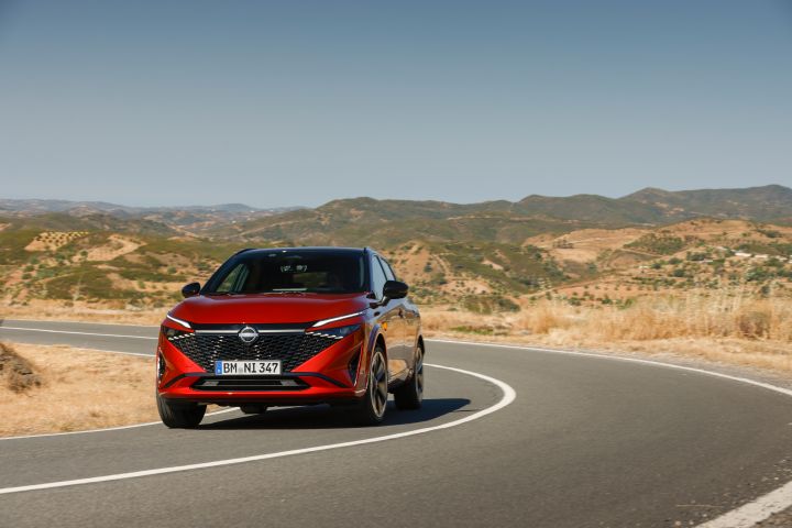 ¾ view of New refreshed Qashqai 2024 in fuji sunset color driving on the road in Faro, Portugal