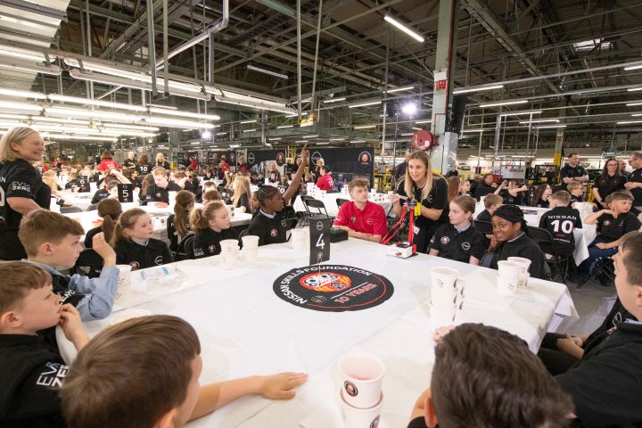 Schoolchildren sitting at the table during the Nissan Skills Foundation event, listening to the instructions