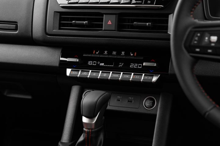 2026 Nissan Navara PRO-4X finished in Boulder Grey showing the mid-dash layout with centre vents, hazard switch, climate panel and automatic shifter.