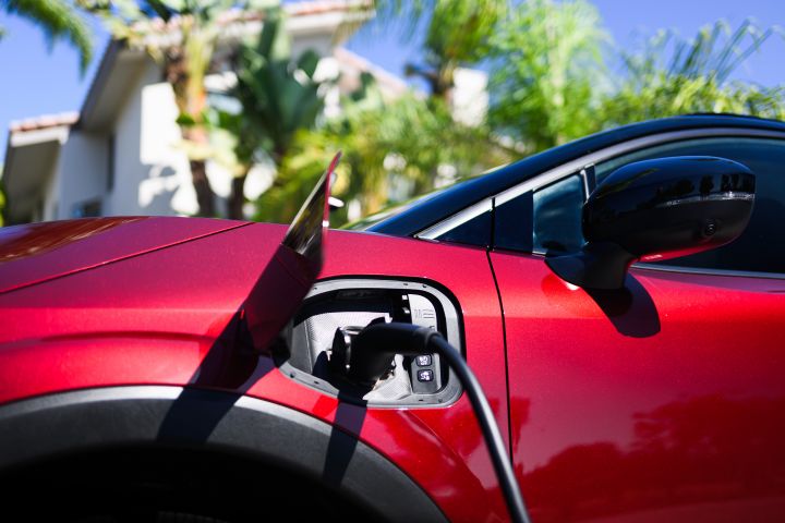 The charging port on the side of the 2026 Nissan LEAF being used.