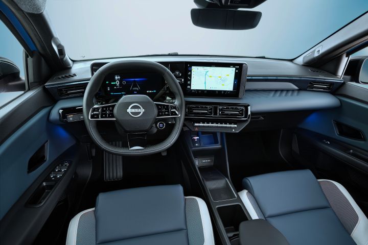 Driver pov of full dashboard cockpit showing steering wheel, driver focused infotainment, rear view mirror, front seats and side mirrors