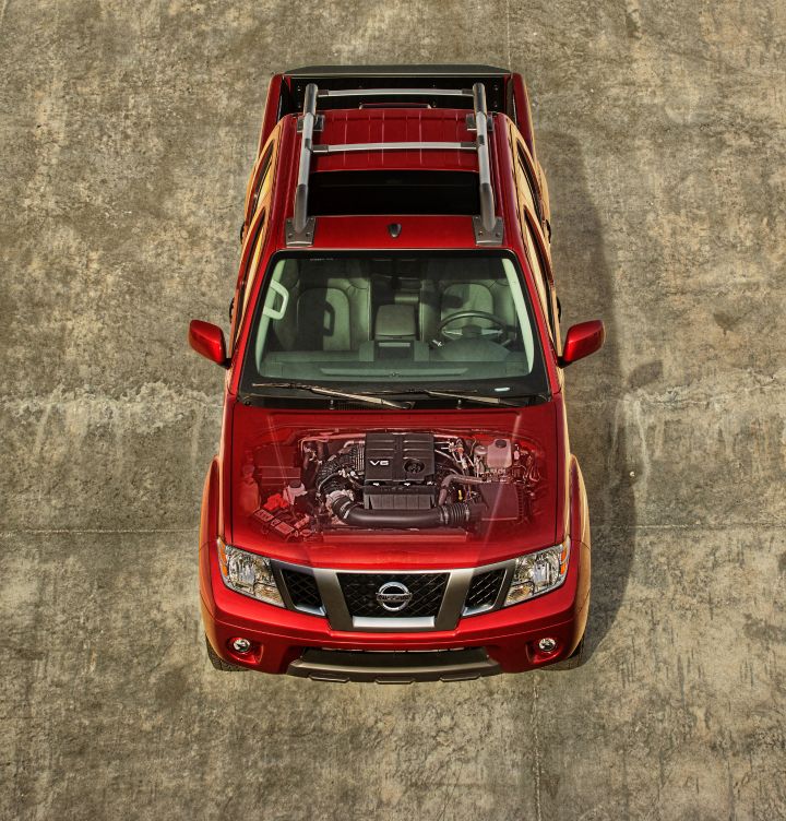 Aerial view of a red Nissan Frontier with faded hood showing the engine compartment