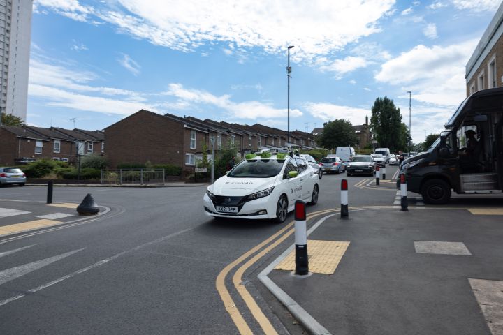 Front dynamic shot of evolvAD on a residential route approaching a pedestrian crossing