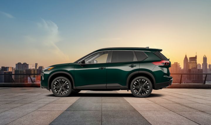 Side profile view of the 2026 Nissan Rogue Dark Armor during sunset on a rooftop.