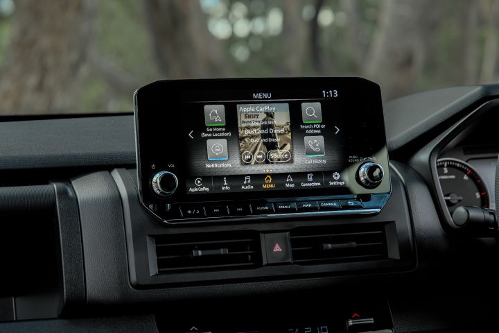 2026 Nissan Navara ST dual cab ute finished in Summit Silver featuring the dashboard touchscreen with smartphone connectivity icons and centre air vents.