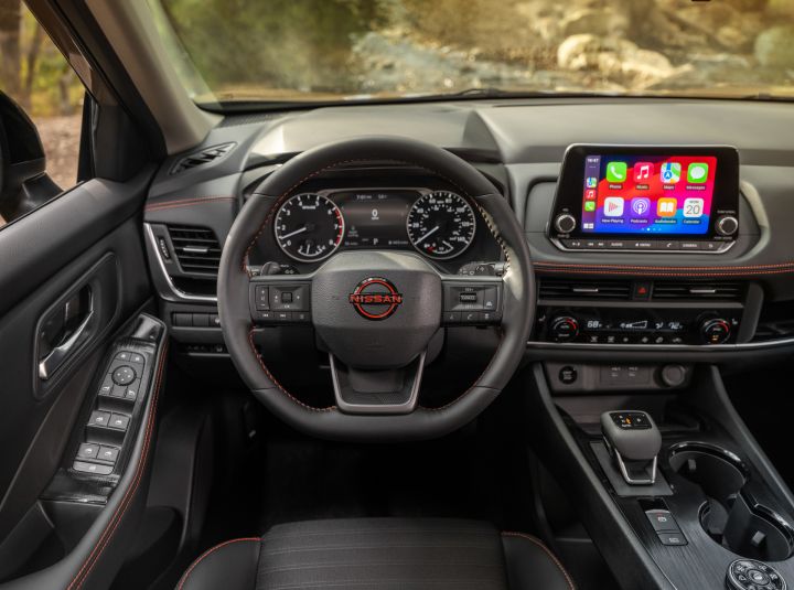 The steering wheel and driver controls inside the 2025 Nissan Rogue rock creek.