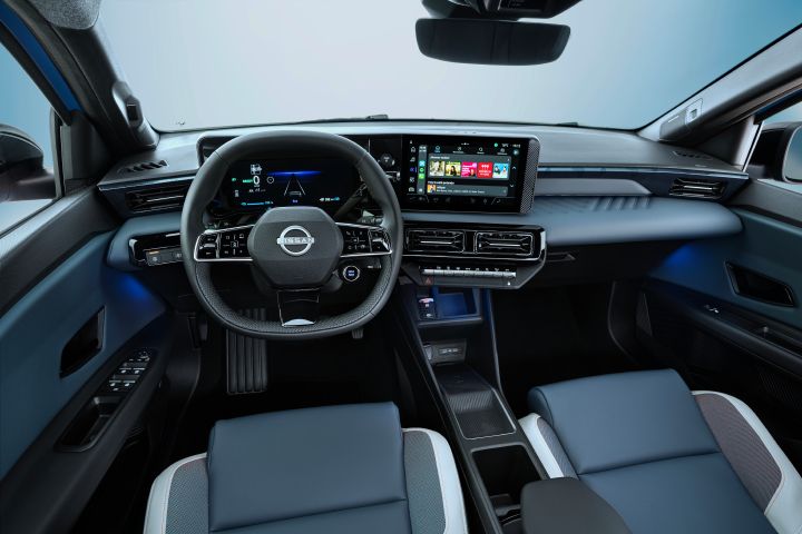 full dashboard view of cockpit from driver POV showing steering wheel. driver focused infotainment, front seats, and blue ambient lights below the dashboard.  Google play store apps on screen