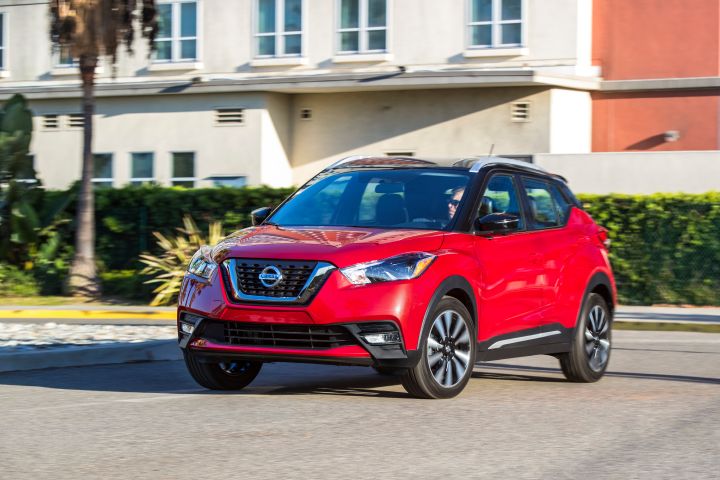 A red Nissan Kicks parked outdoors.