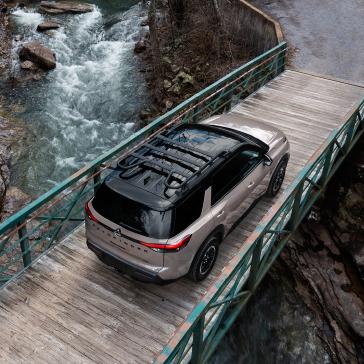 Nissan Pathfinder over creek close up.