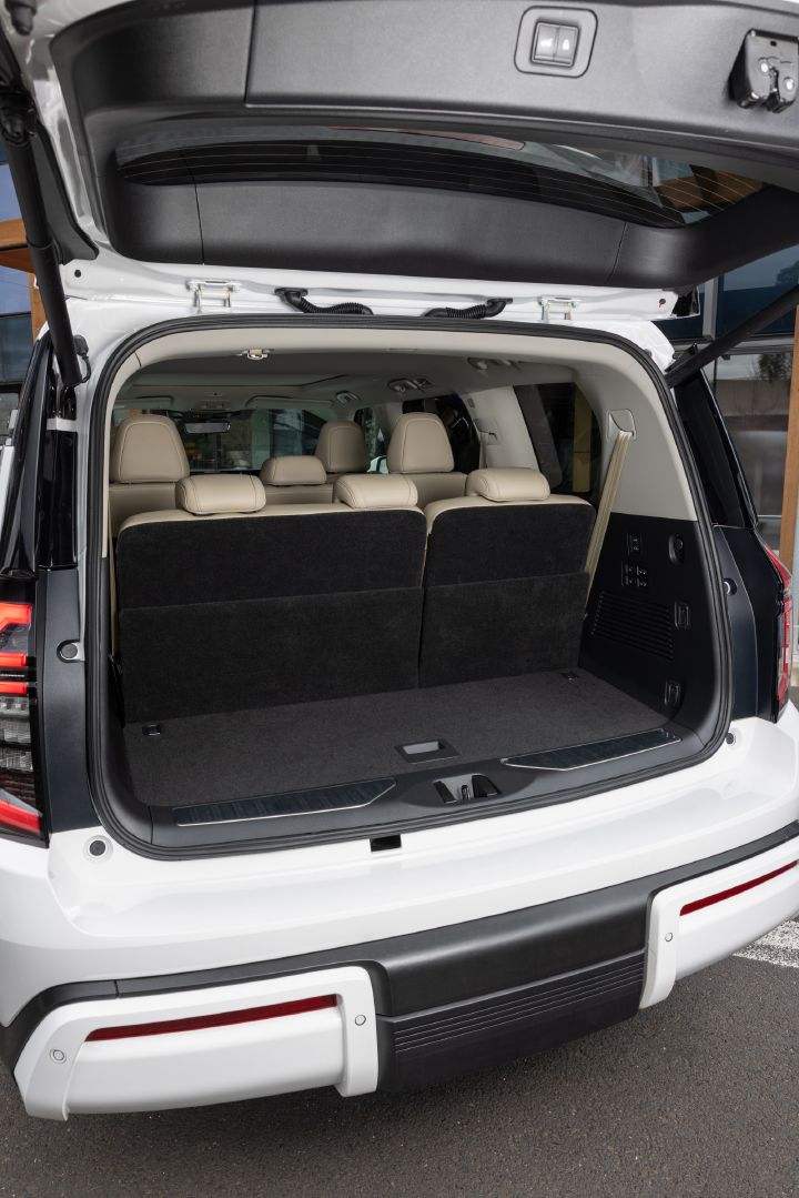 2026 Nissan Y63 Patrol finished in white, rear cargo area shown with the tailgate open and all three rows of seats upright, highlighting luggage space behind the third row.