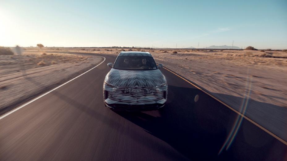 The all new QX60 with driver and passenger in it on the road