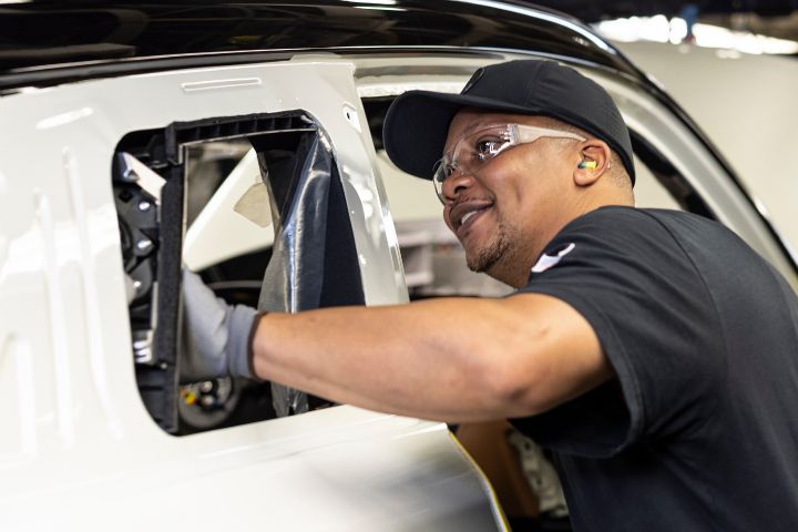 Image of a manufacturing team member assembling a vehicle