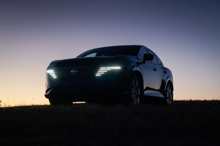 Lower angled view of the 2026 Nissan Murano at nighttime with the headlights illuminated.