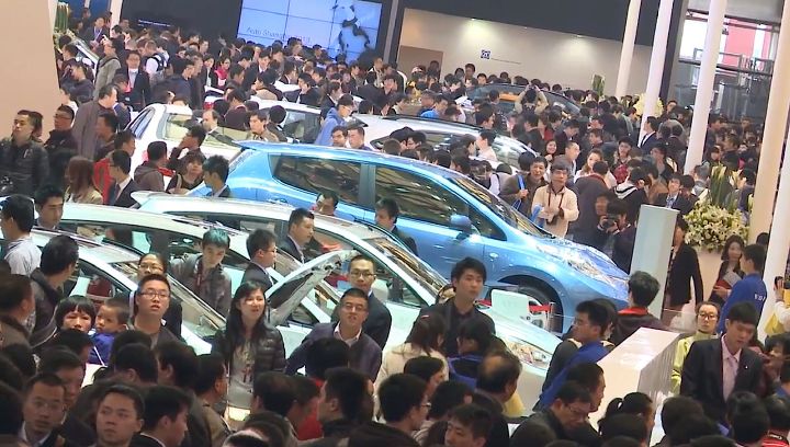 many people around several vehicles