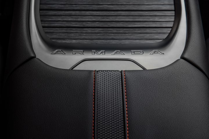Close up of the leather interior, accented stitching, and accordion cover on the center console of a 2025 Nissan Armada.