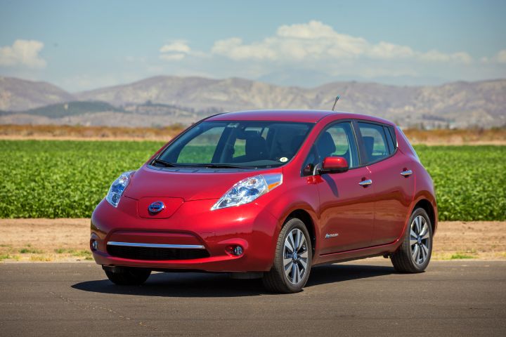 a red Nissan LEAF pictured in a grassland