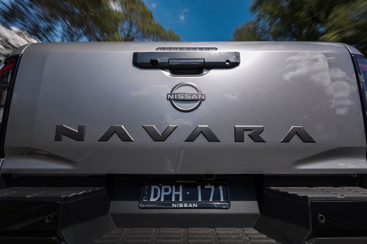 2026 Nissan Navara ST dual cab ute finished in Summit Silver shown in a rear tailgate close-up with NAVARA embossing, Nissan badge and black bumper step.
