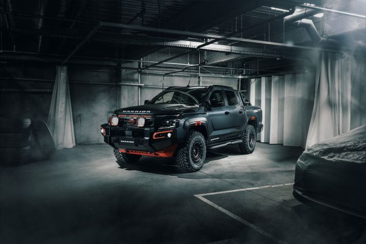 Static front ¾ exterior shot of a black 2026 Nissan Navara WARRIOR dual-cab ute concept car