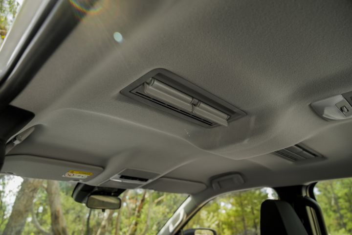2026 Nissan Navara SL dual cab ute finished in Alpine White featuring the interior roof lining, overhead lighting modules, visor edge and upper cabin trim details.
