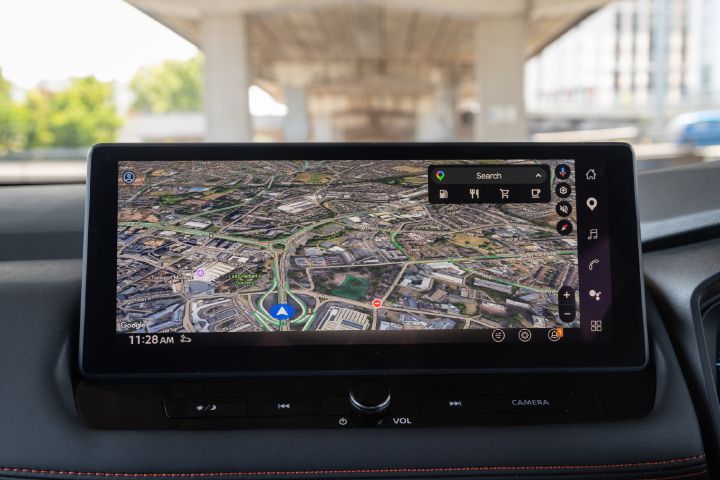 Close-up of the Nissan X‑Trail infotainment touchscreen, displaying Google Maps navigation with search and points of interest options.