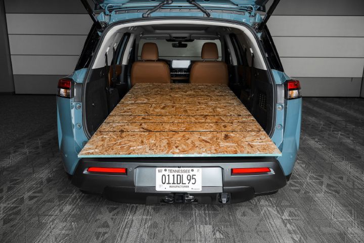 A large piece of chip board in the back of the 2026 Nissan Pathfinder with the second and third row seats