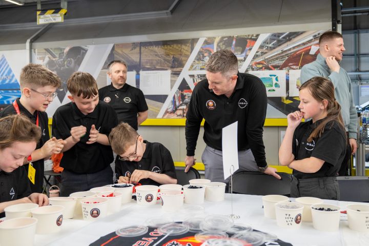 Michael Jude speaking with school children as they build a small LEGO Nissan Qashqai
