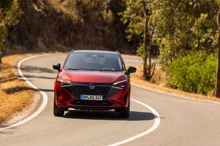 Front view of New refreshed Qashqai 2024 in fuji sunset color driving on the road in Faro, Portugal