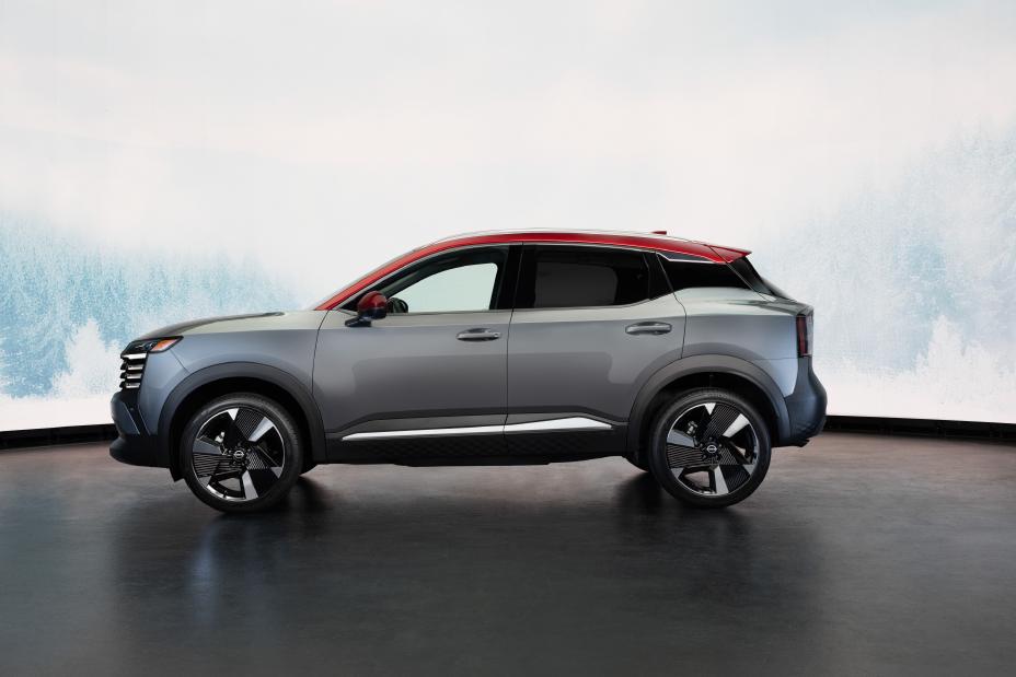 Left profile view of the 2025 Nissan Kicks parked against a wintery white background with trees.