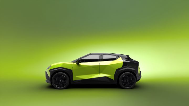 Against a bright green background, a Juke EV is shown from the side, facing to the right in a studio-like setting.