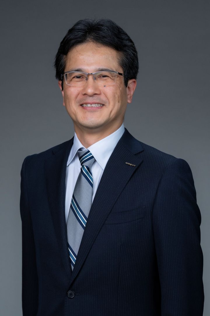 Portrait of Teiji Hirata (suit, tie and NISSAN corporate pin) (smiling)