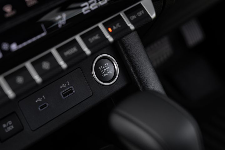 Close-up of the lower dashboard controls in a 2026 Nissan Navara ST-X, showing the Start Stop Engine button, USB-C and USB-A ports, and adjacent climate-control buttons.