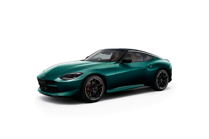 Fairlady Z finished in Unryu Green, photographed in a light gray studio setting. The vehicle is shown from a front-left three-quarter angle, with the front end facing toward the left side of the image. A black roof and black alloy wheels complement the classic long-hood, short-deck sports car proportions. The clean studio background emphasizes the rich Unryu Green body color and the sculpted exterior design of the coupe.