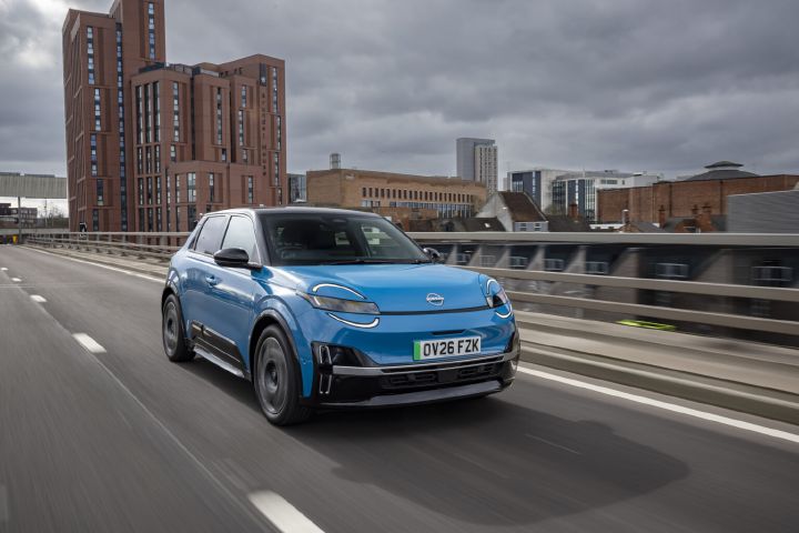 Blue all-new MICRA driving on an urban road.