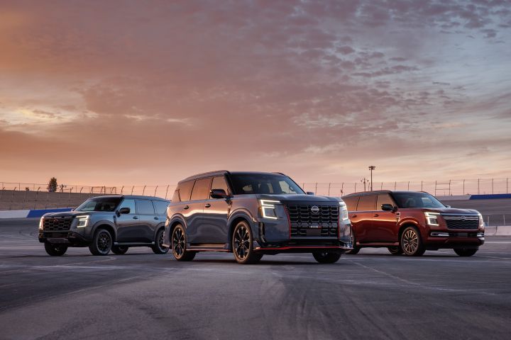 Three 2026 Nissan Armada NISMOs parked in different directions during sunset, their headlights are on.