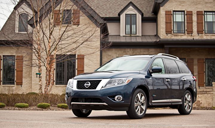 a 2014 Pathfinder Hybrid next to a residence