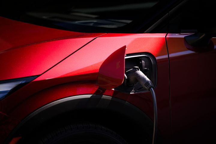 A charger attached to the charging port on the 2026 Nissan LEAF.