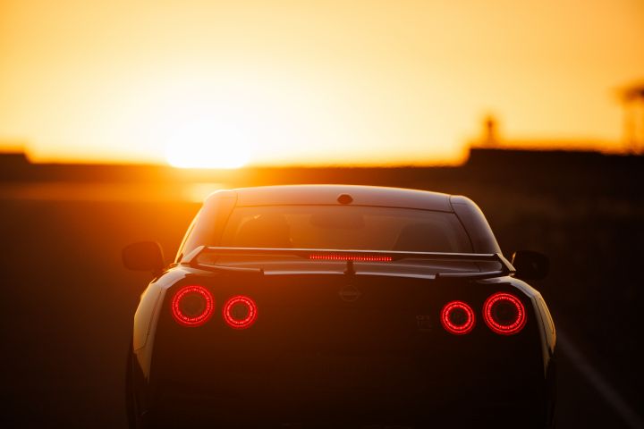 Rear of 2024 GT‑R Special Editions parked with a bright sunset in the background