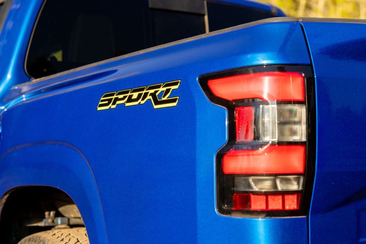 Close up of the left taillight and truck bed decal that reads "SPORT" on the 2027 Nissan Frontier Sport Edition.