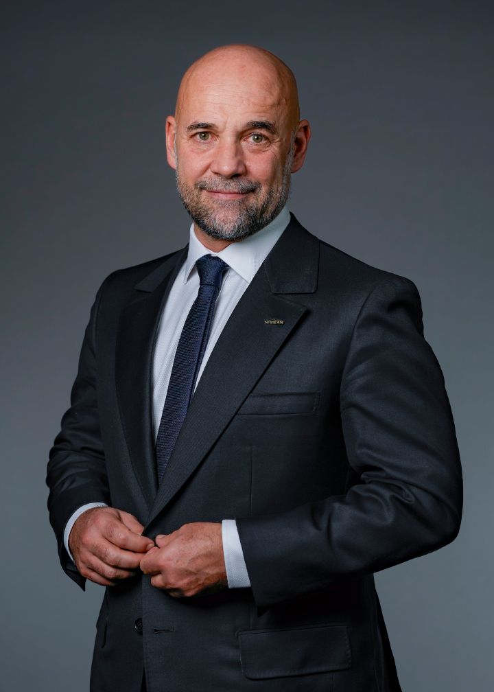 Portrait of Guillaume Cartier (suit, tie and NISSAN corporate pin)