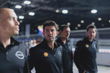 Nissan Formula E Team members walking down a road.