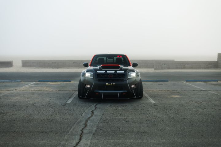 Front view of the Nissan Frontier Tarmac, parked in a lot on a foggy day.